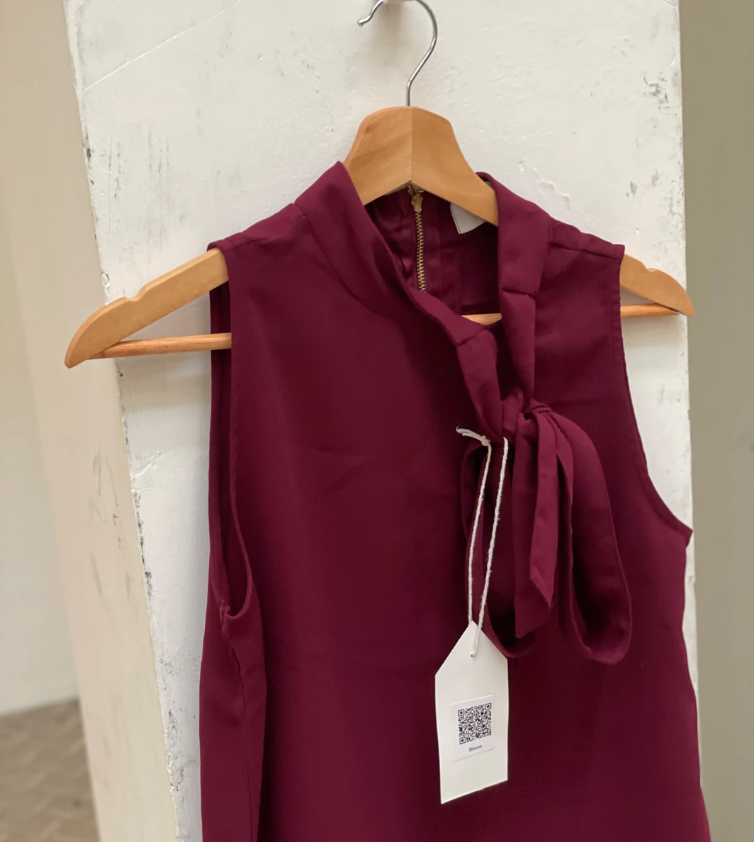 Exhibition — burgundy blouse with QR tag
