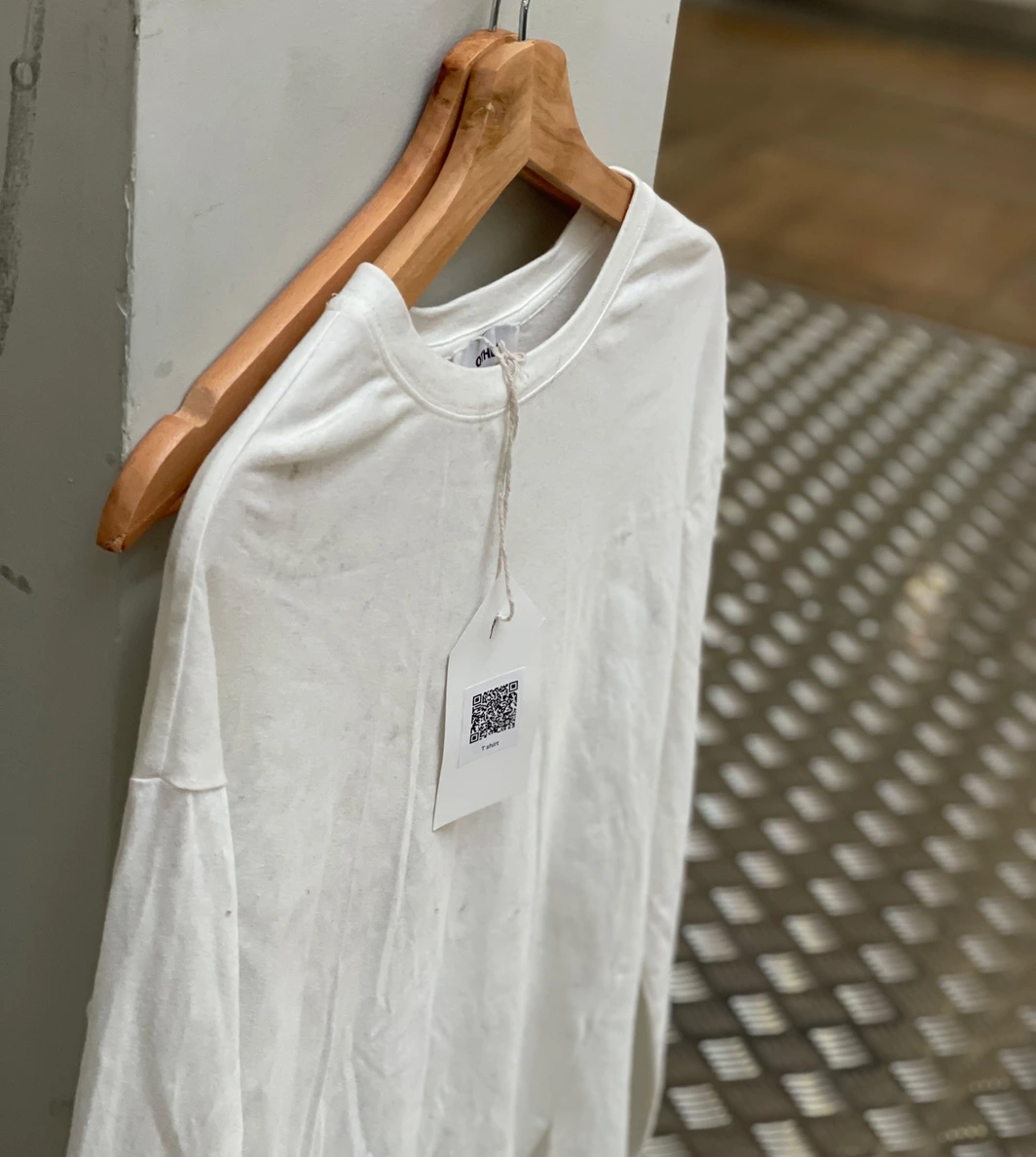 Exhibition — white t-shirt on hanger with QR tag