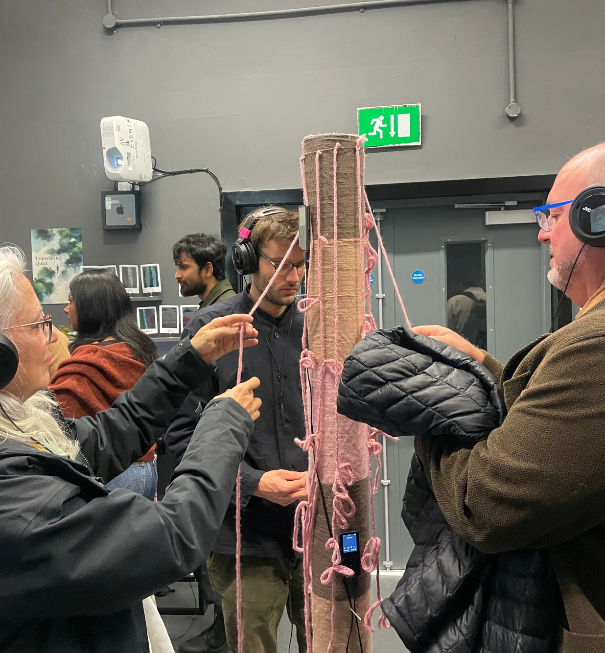 Exhibition — multiple visitors engaging with the installation