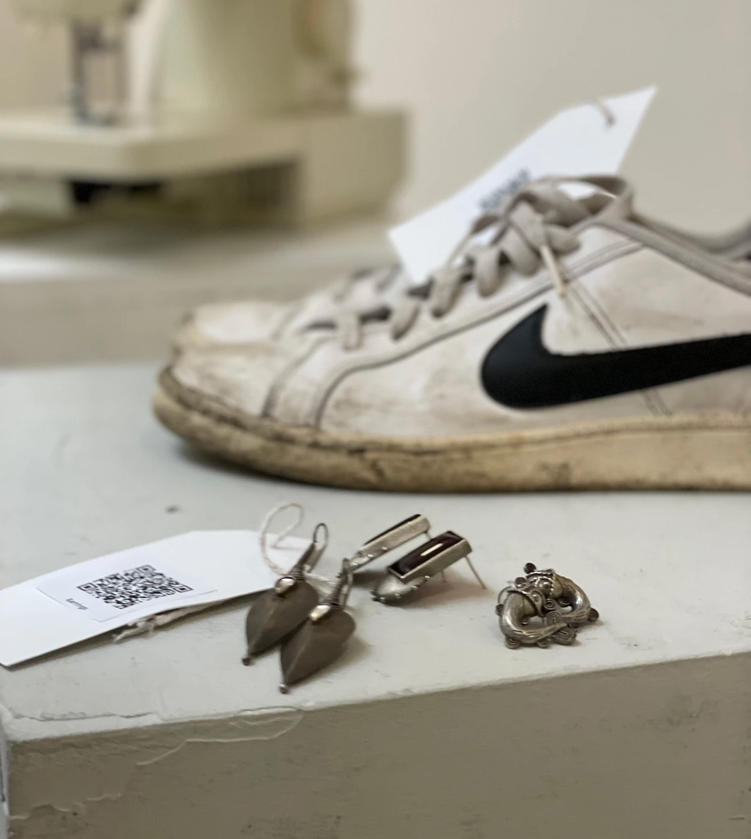 Exhibition — worn Nike trainers with QR tag
